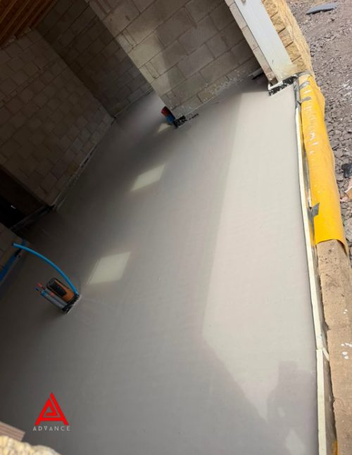Liquid screed pumped out and levelled across a new floor